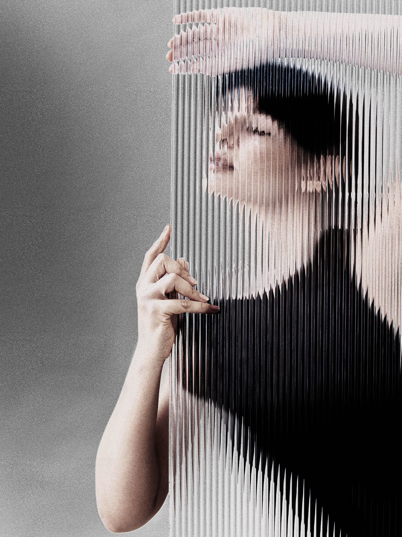Portrait glimpsed through fluted glass, the figure dissolving into vertical striped bands of light and dark