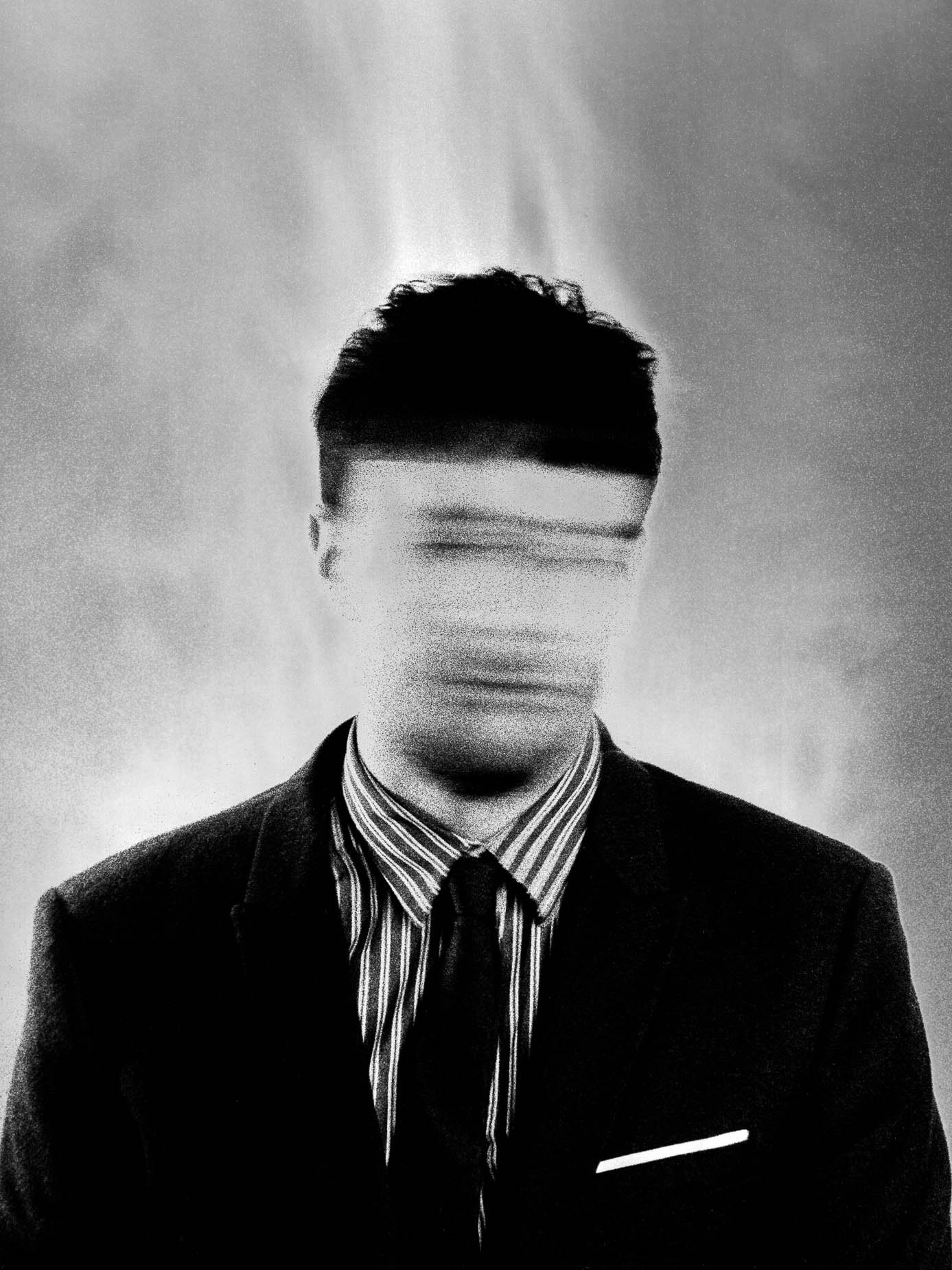 A man in a striped shirt and tie, his face streaked into a horizontal motion blur, hair and shoulders in sharp focus