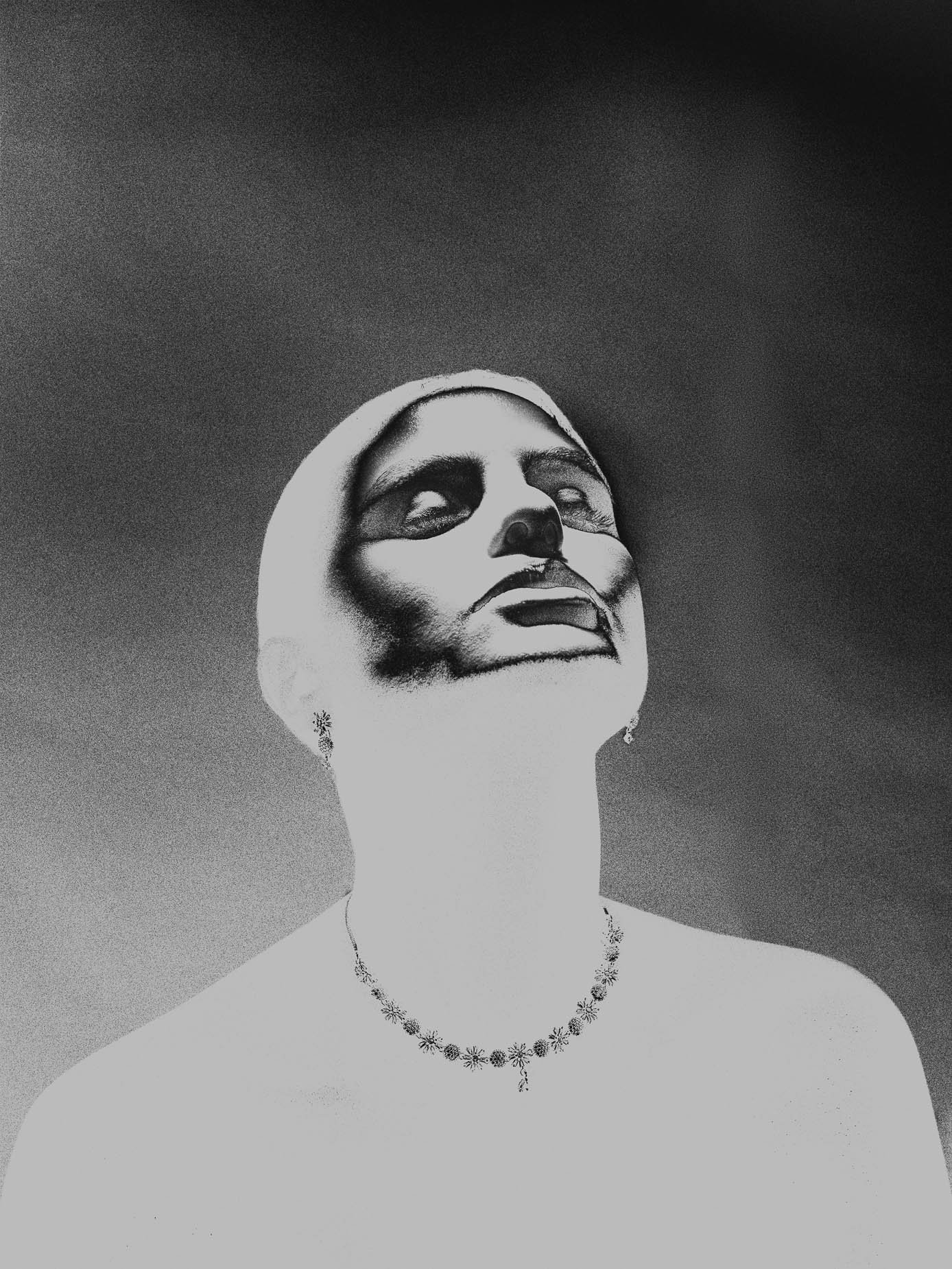 A figure with head fully tilted back, features lost in shadow, throat and necklace lit against a dark gradated background